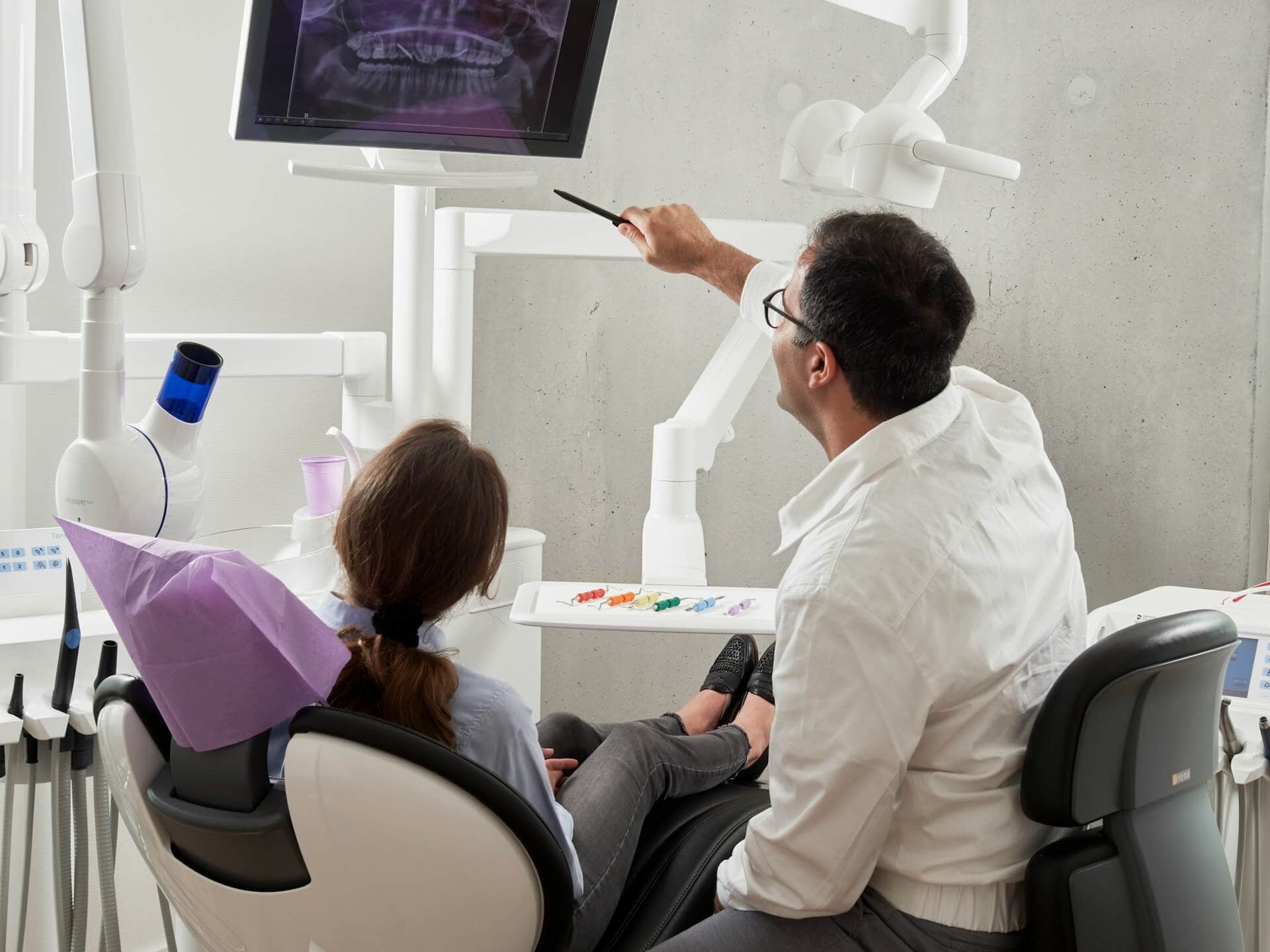 A dentist and a patient talking to each other