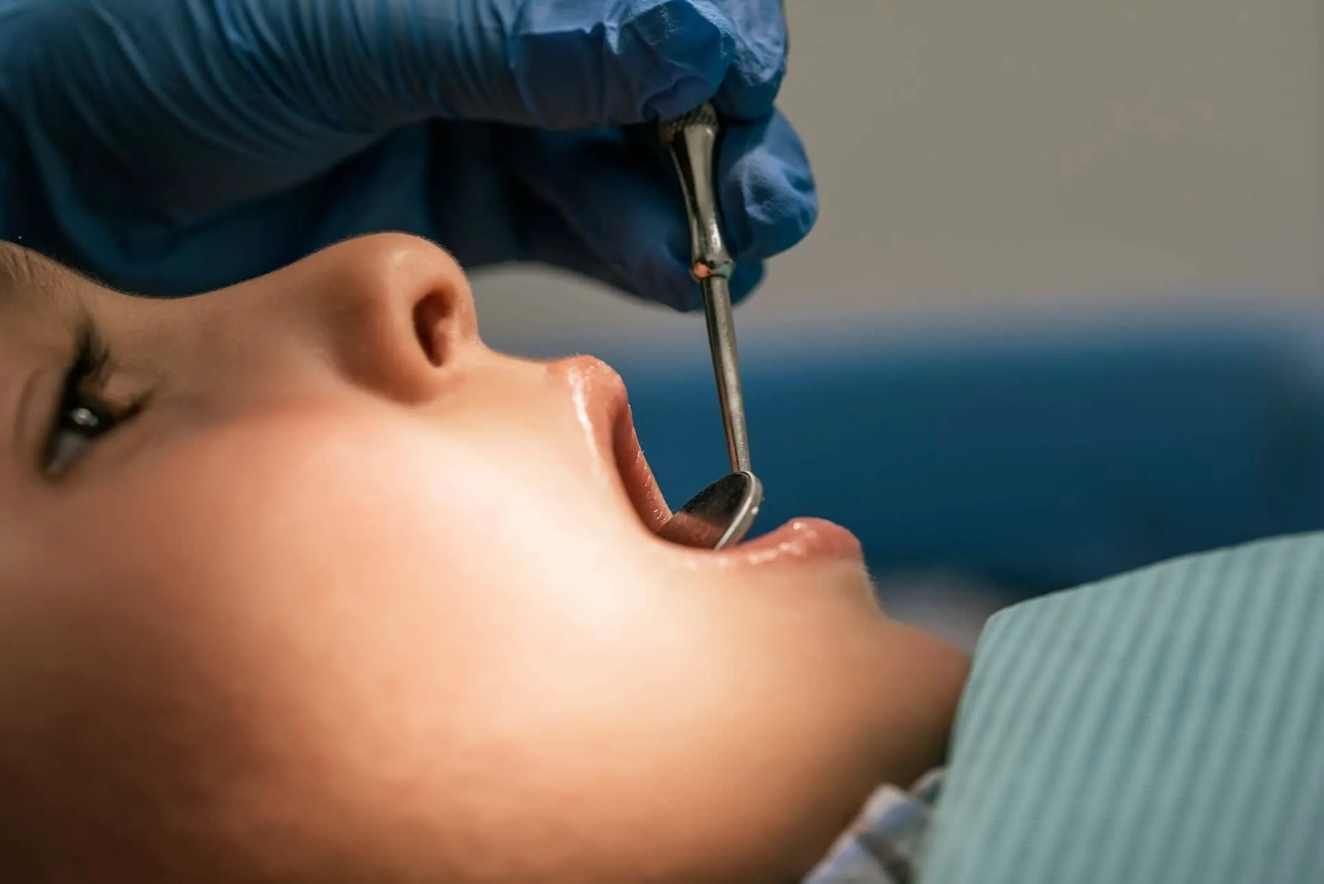 A person being checked on the teeth