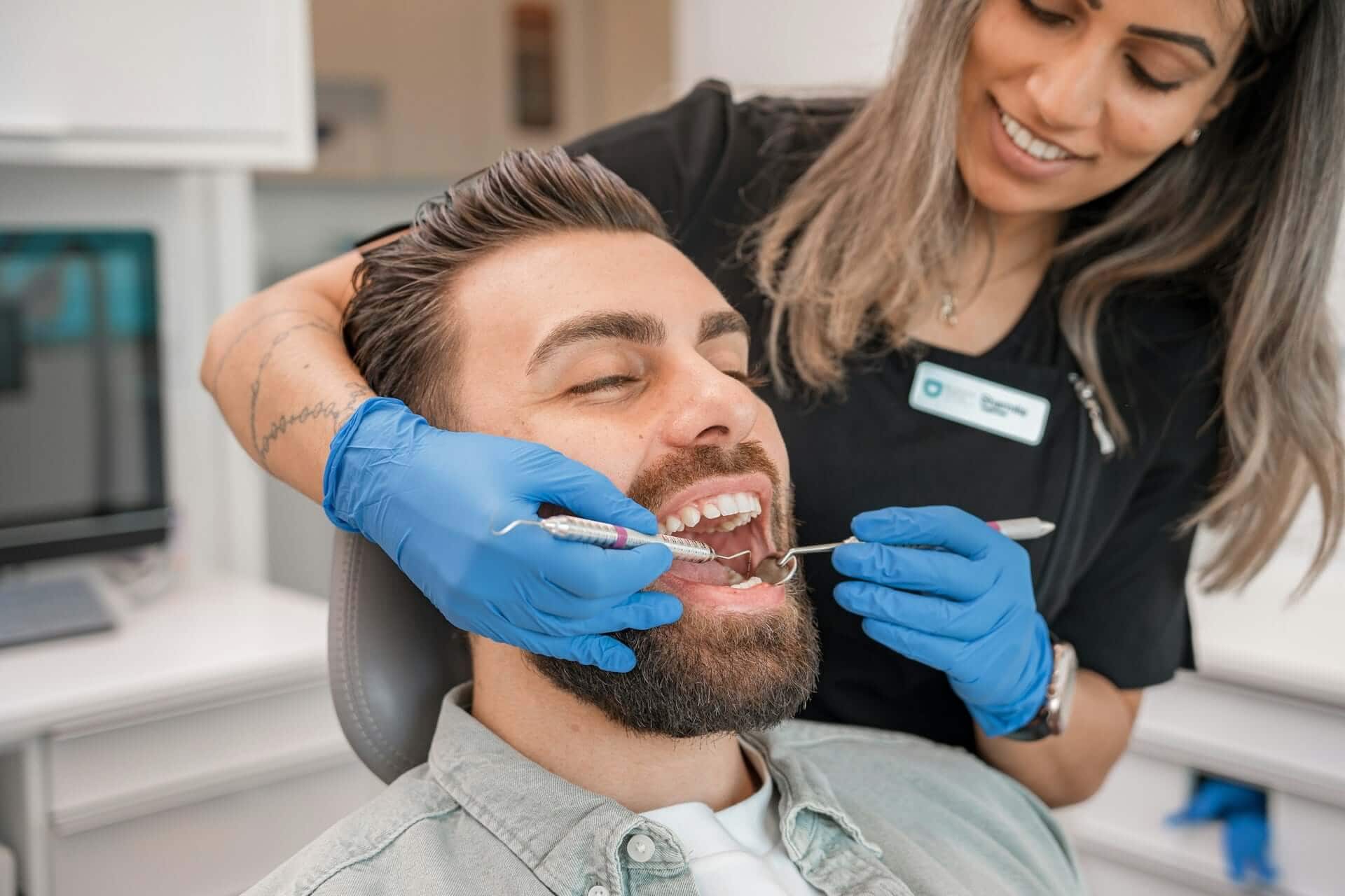 patient smiling after cosmetic treatment, showcasing how dental bonding can repair chipped