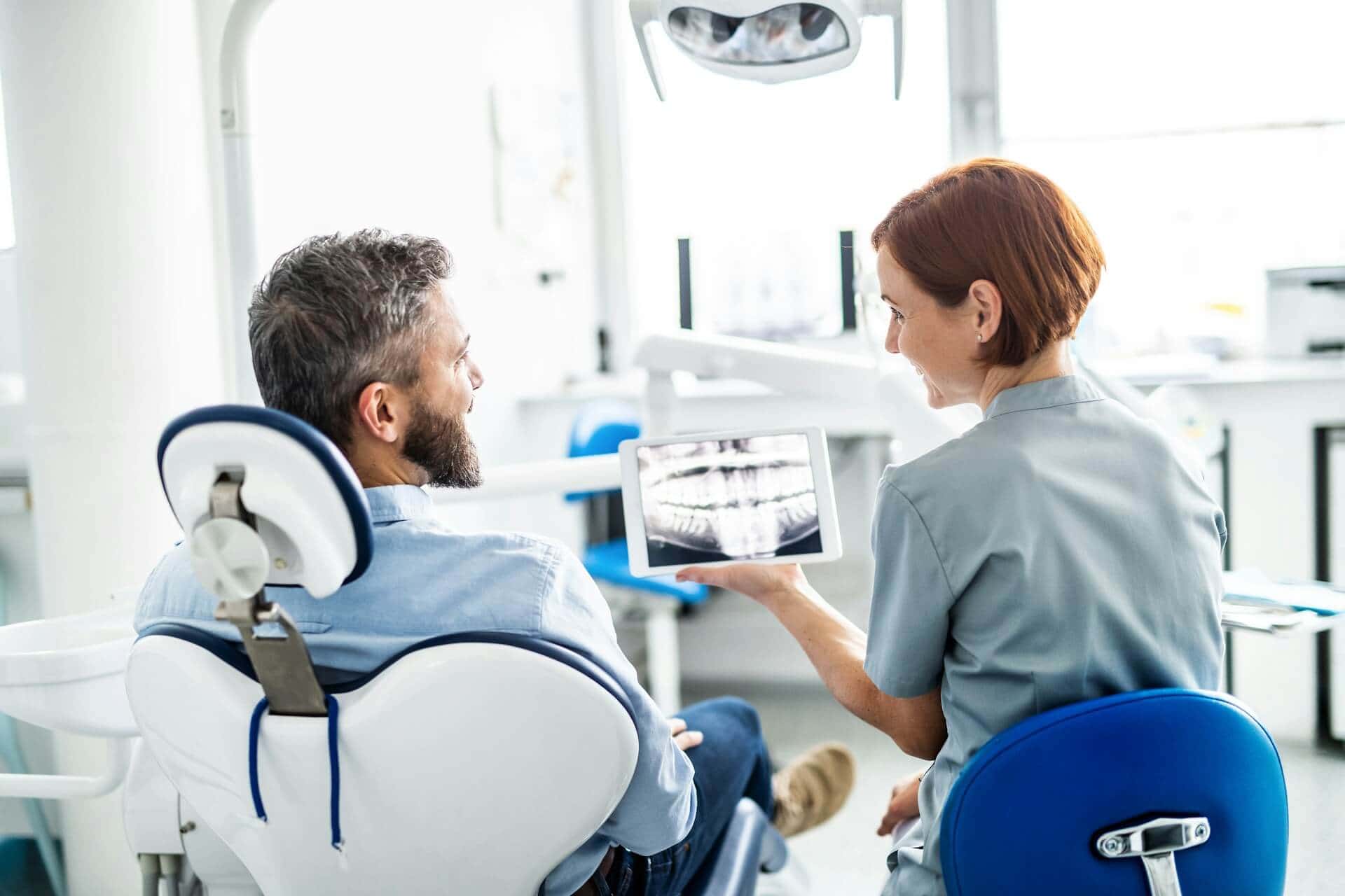 A woman showing an x ray of the whole teeth