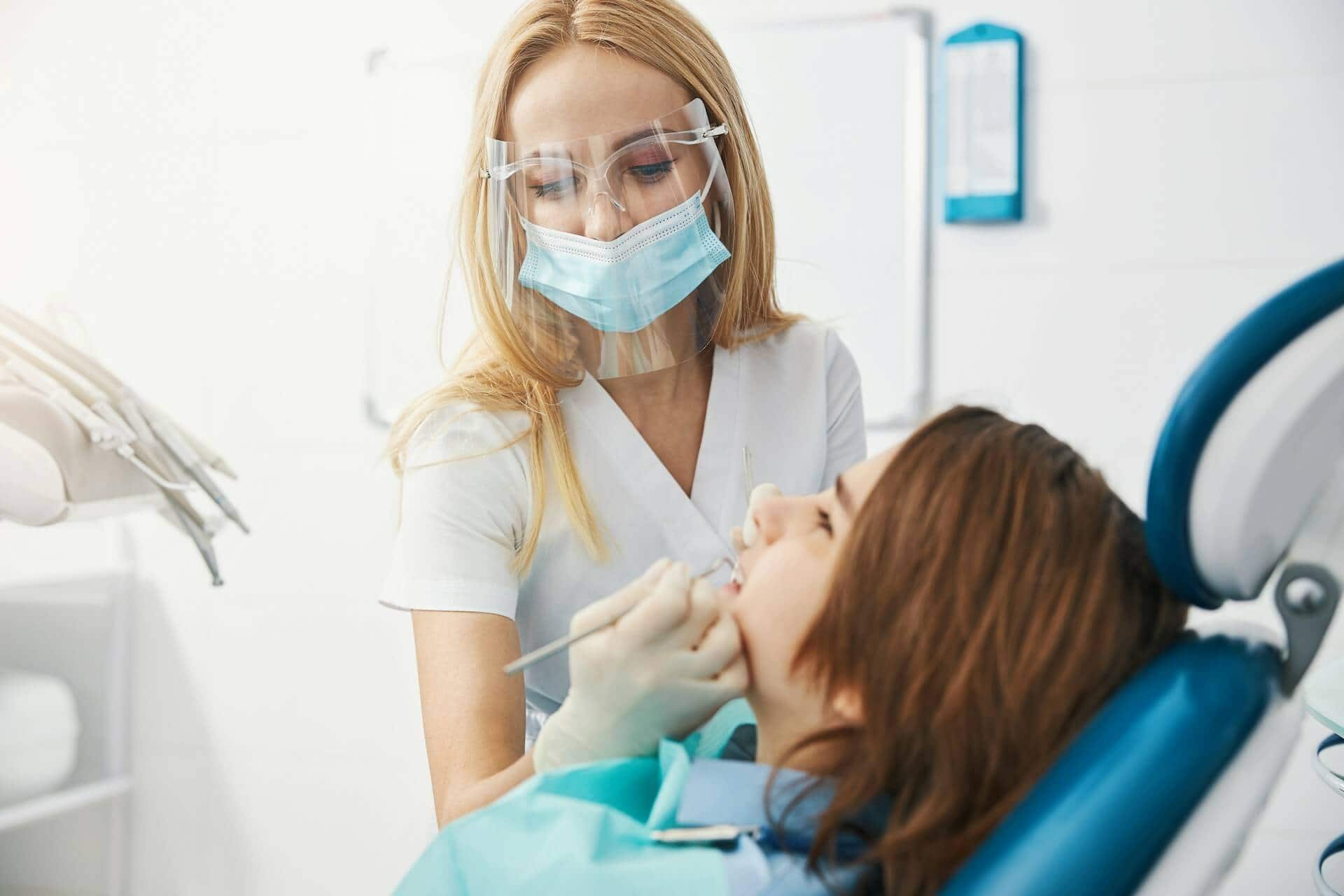 A person checking a person's teeth