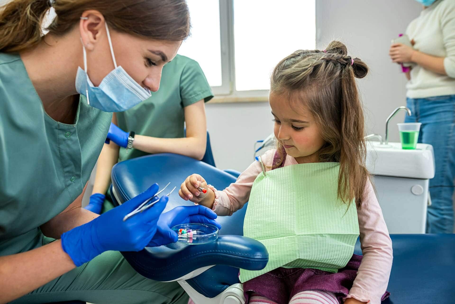 A child and a woman wearing a blue gloves
